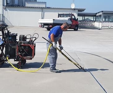 An employee processes joints with a machine
